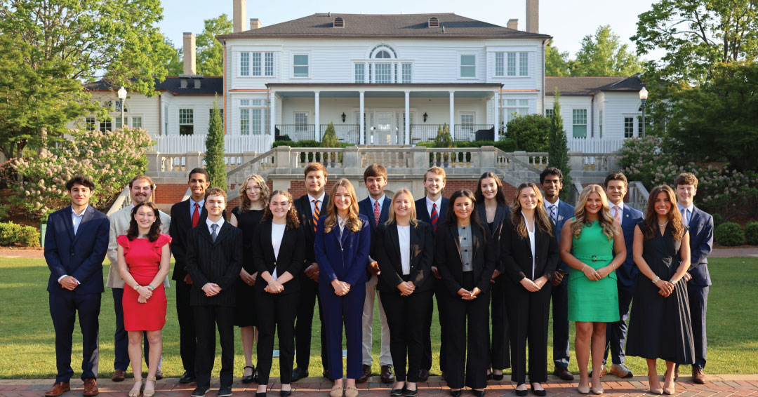 Students from across colleges selected as Foundation Fellows pose for a group photo outside the president's home