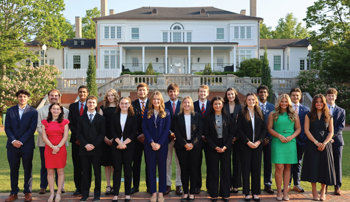 Students from across colleges selected as Foundation Fellows pose for a group photo outside the president's home