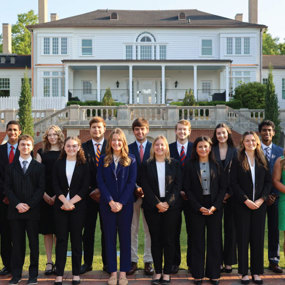 Students from across colleges selected as Foundation Fellows pose for a group photo outside the president's home
