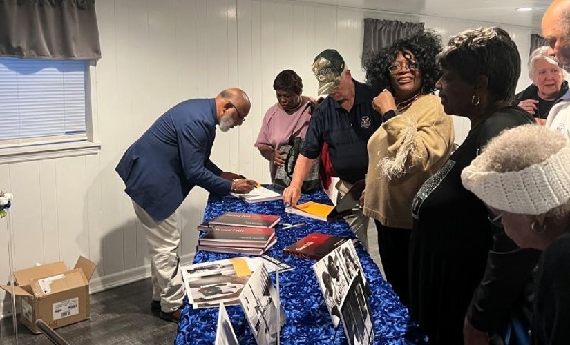Chester Higgins signing books