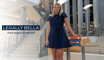 Isabella Dee with books in the RBD Library at Auburn