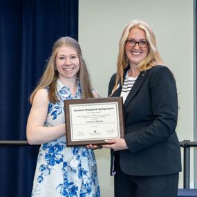 Cambria Beane accepting the award for best graduate poster presentation