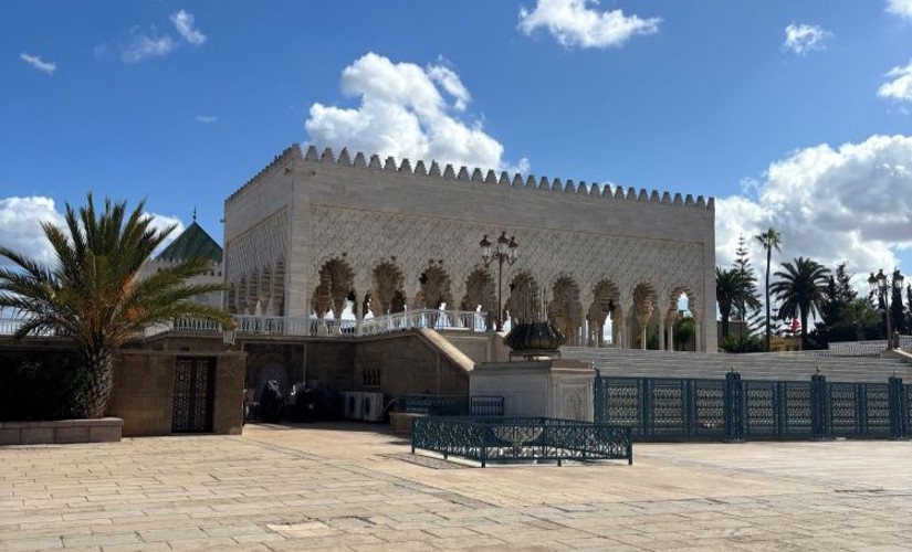 A historic, intricately designed building in Morocco under a clear blue sky