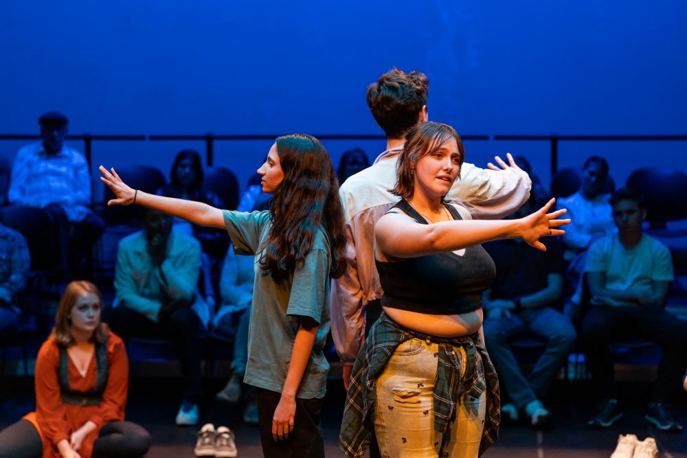 Students performing original, devised work in "Body Maps" onstage