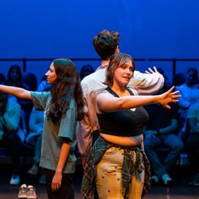 Students performing original, devised work in "Body Maps" onstage