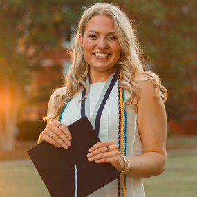 Katie Jett posing with graduation cap outside Samford Hall