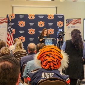 Aubie sitting in the audience of the Opelika TBI center ribbon cutting ceremony