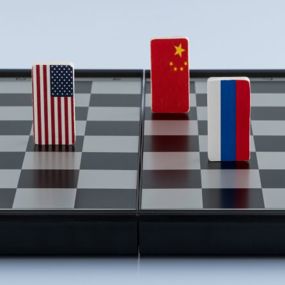 US, China and Russia flags as pieces on a chess board
