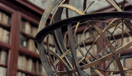 Globe on a desk in front of bookshelves in Rome's national library