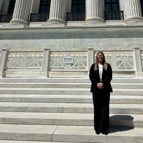 Lilli Wellbaum standing on the steps of the U.S. Supreme Court building
