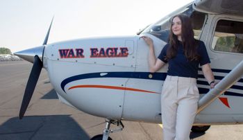 Jessica McGrath standing beside an Auburn airplane