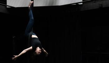 Sydney Pereira hanging upside down on aerial fabrics