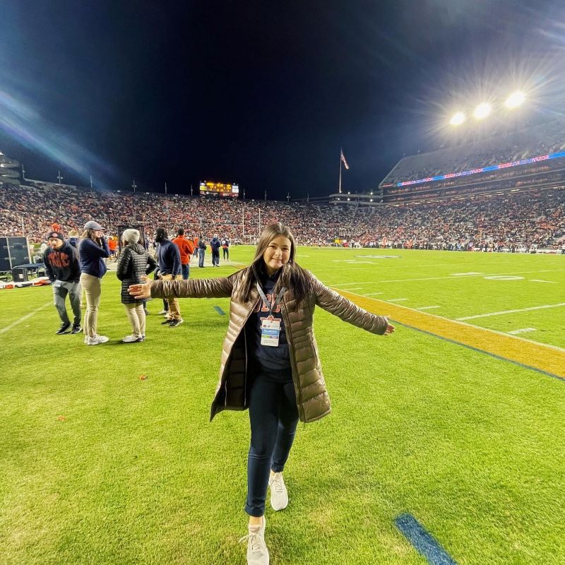 Mattie Whitney poses on the field at Jordan Hare Stadium