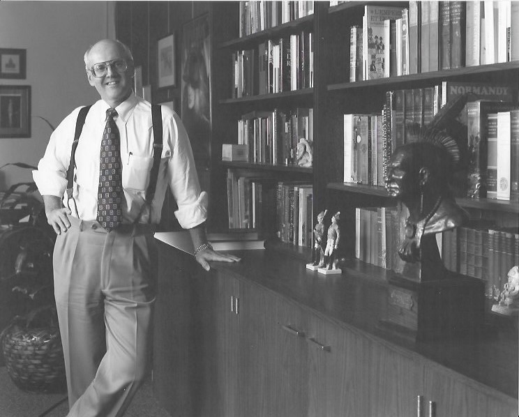 Gordon Bond poses inside the Thach Hall library that is now named in his honor