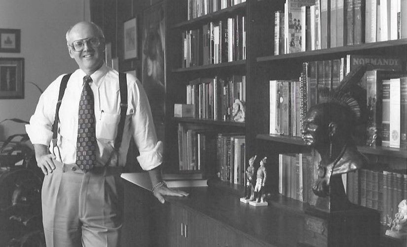 Gordon Bond poses inside the Thach Hall library that is now named in his honor