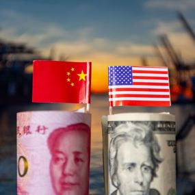Chinese flag and money beside US flag and money