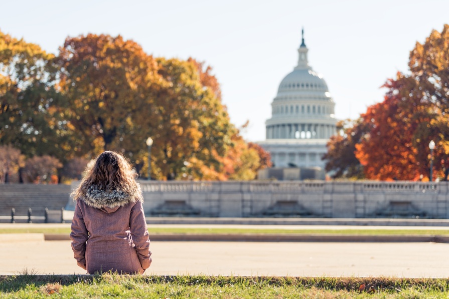Girl sitting in front of US Capitol building