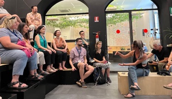 People sitting and listening to a speaker 