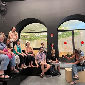 People sitting and listening to a speaker 