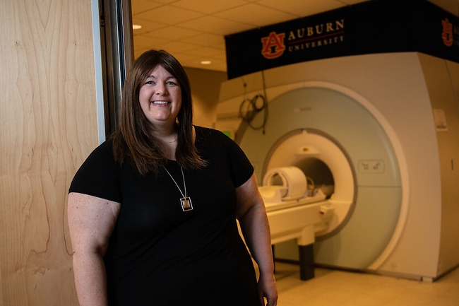 Jennifer Robinson standing in front of MRI machine