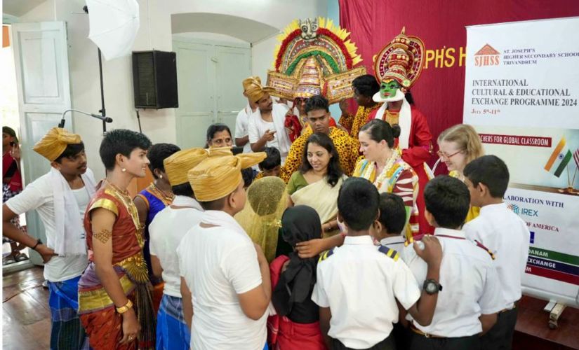 Laura West Ramkorun and a St. Joseph's teacher with students