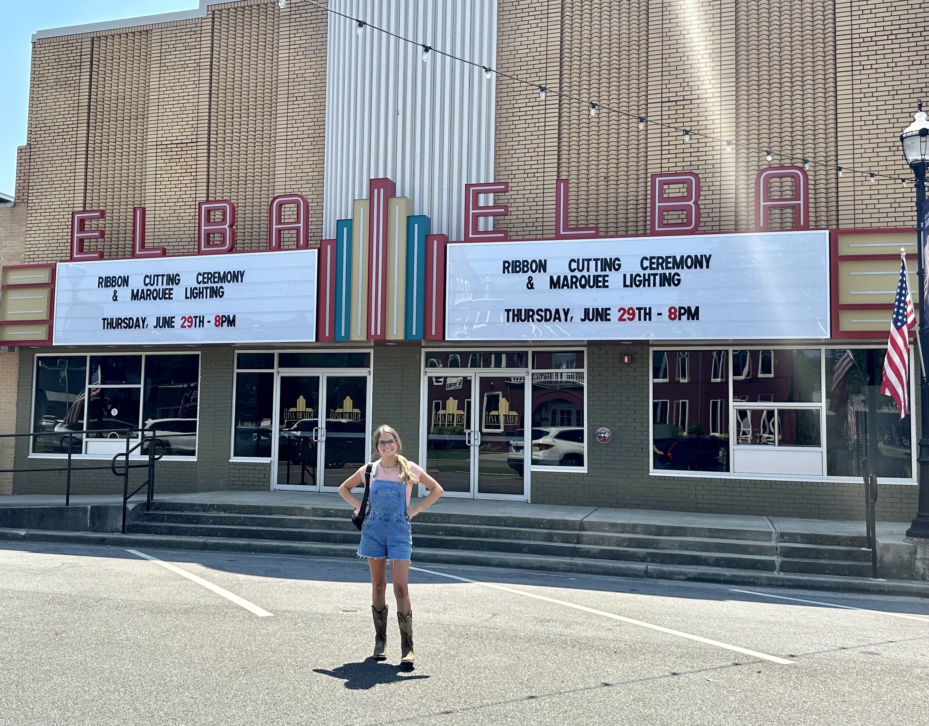 Mikailie stands in front of the new marquee on display at Elba Theatre