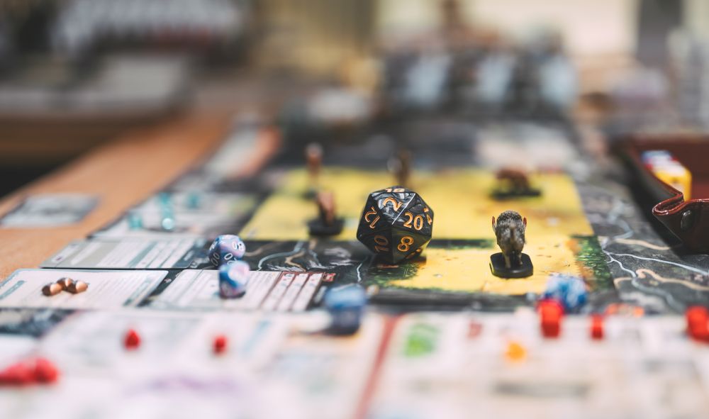 Tabletop role-playing game set up with figures, maps and dice