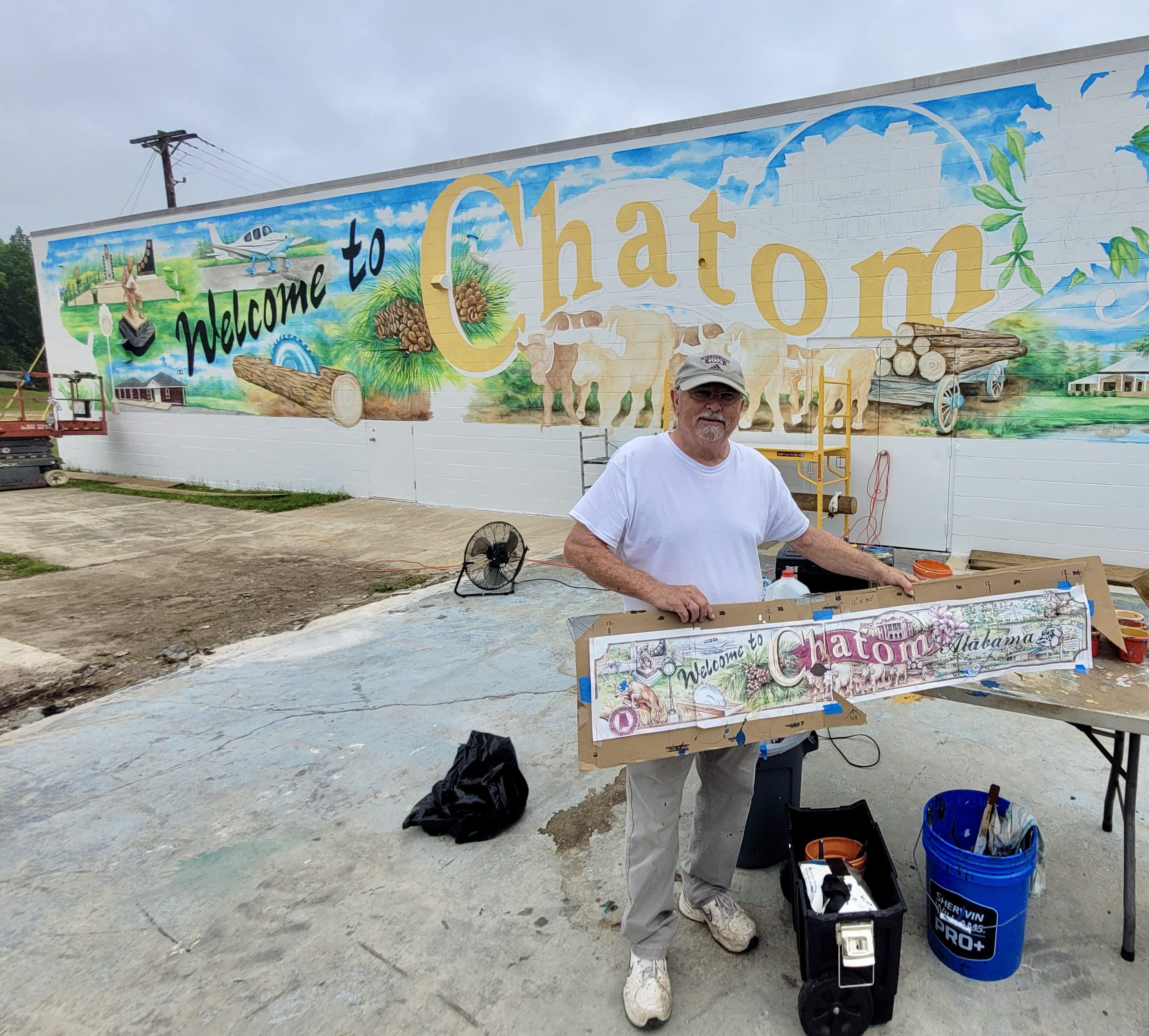 Artist Joe Wilson stands in front of the new mural soon to be officially unveiled.