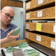 Nickolas Long examining broken bottles on a lab table