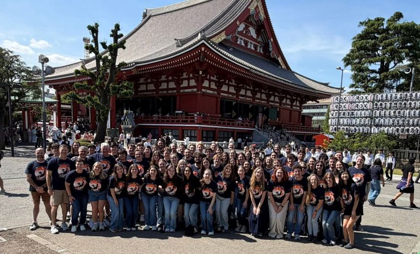 Group of Auburn band students in front of a building in Japan