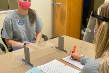 Student working with a client in the speech and hearing clinic