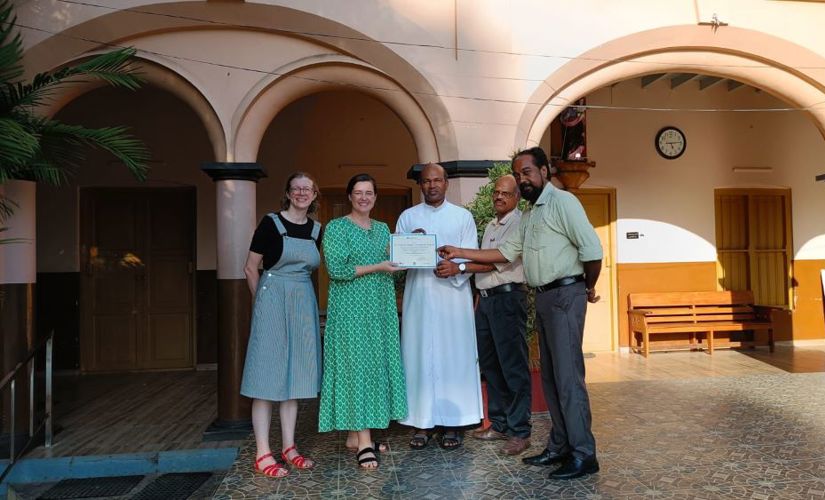 St. Joseph's School presenting a certificate to Laura West Ramkorun