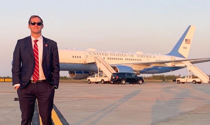 Cody Sanders standing in front of Air Force One