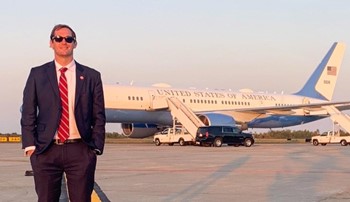Cody Sanders standing in front of Air Force One