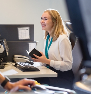 Woman At Customer Service Desk