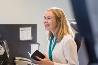 Woman At Customer Service Desk