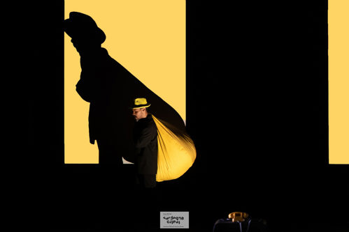 Male performer in black and yellow stage
