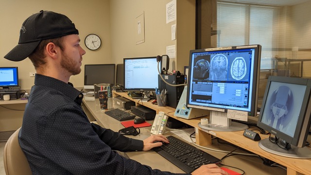 Steven Nichols sitting in front of a computer