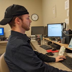 Steven Nichols sitting in front of a computer