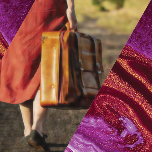 woman in a red dress walking with a suitcase on a sunny day