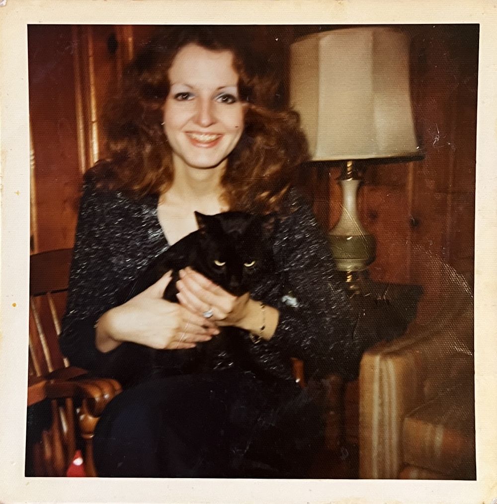 Kathy smiling for the camera while holding Duncan