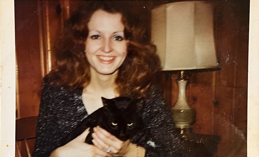 Kathy smiling for the camera while holding Duncan