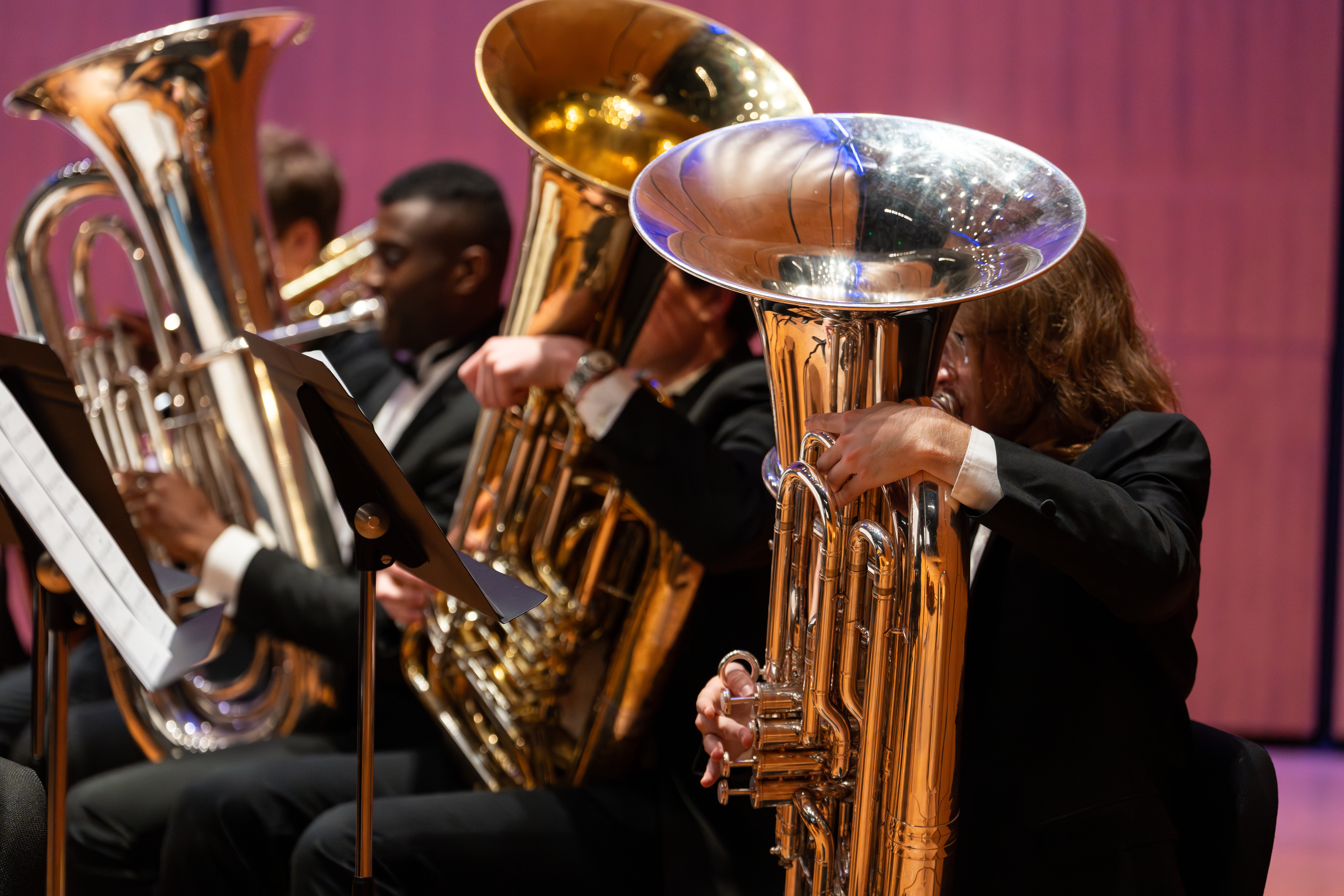 Picture of a student playing a tuba in a concert setting