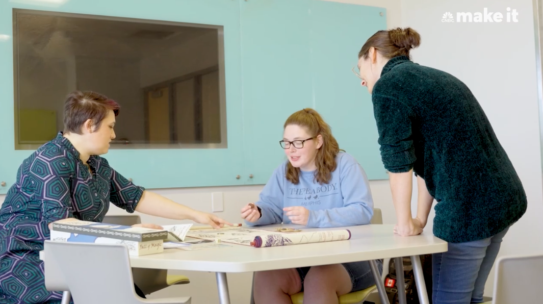 Teacher plays an table top role play game with two students