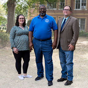 Graduate student Laura King, Selma University President Stanford Angion and Southern History Professor Keith Hebert outside Dinkins Memorial Hall