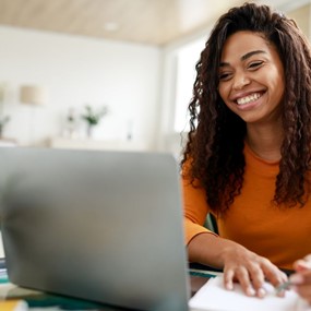 woman sitting in a chair looking at a computer screen
