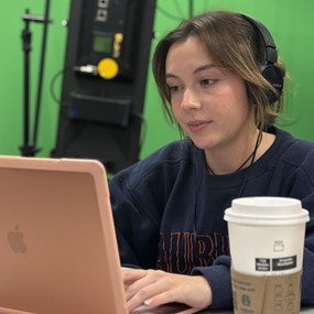 Auburn journalism student calling reporters and working on computer during Election Night