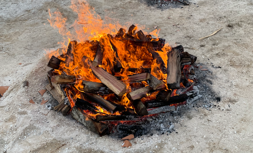 Image of a fire being built on top of the pots
