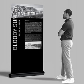 A man looks at a Selma Bloody Sunday display kiosk