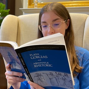 Victoria Ashley reading book about ancient Greek rhetoric